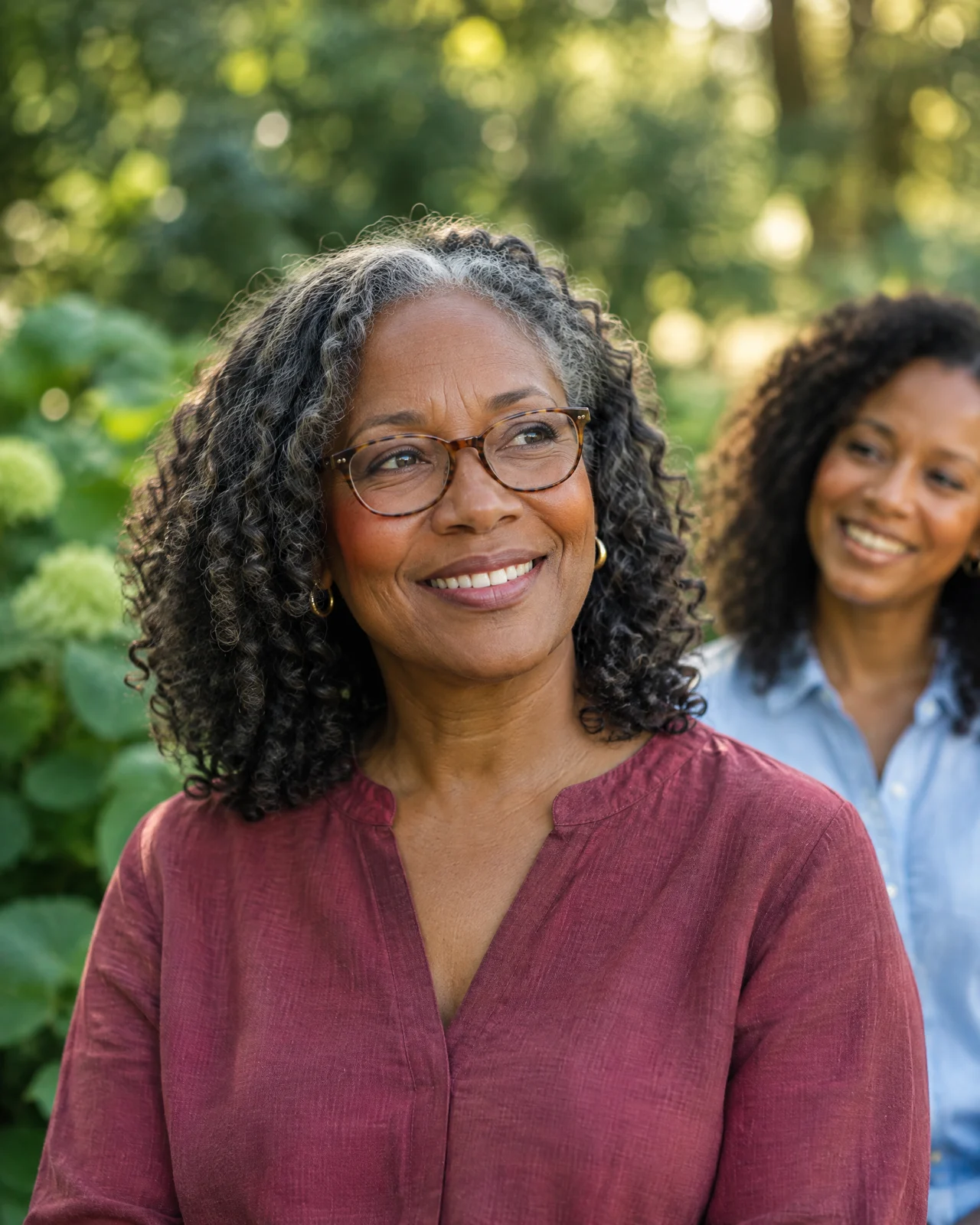 Illustrative lifestyle image of a Black mother and adult daughter enjoying time outdoors